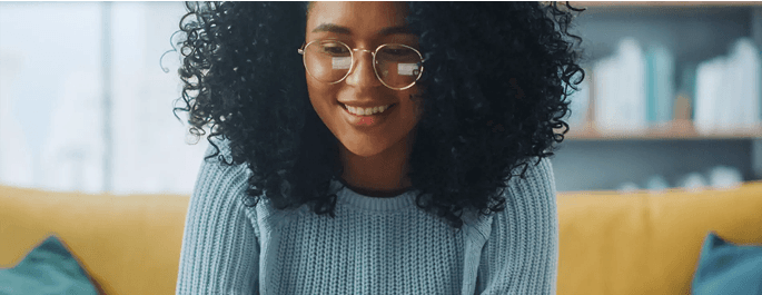 woman with glasses smiling